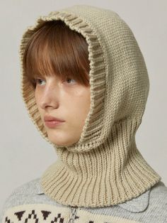 a woman wearing a knitted hood and sweater