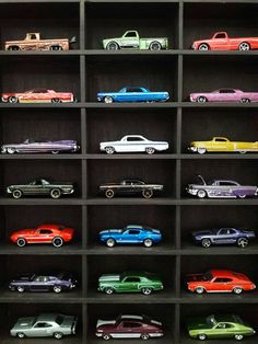 a shelf filled with lots of different colored toy cars