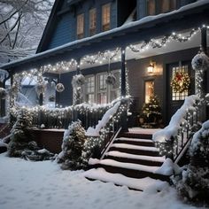 a house covered in snow with christmas lights on the front porch and steps leading up to it