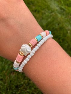 Trendy preppy bracelet 🐚 *Handmade Bracelet set - comes with 2 bracelets (one white seed bead and one blue, coral, white clay bead with shell) *Bracelet length is 6 1/2 inches long with stretchy string *Tie closure Great for stacking or wear alone.  Create your own unique stack with other bracelets from my shop! Willow approved 🐰! Clay Bead Bracelets With Turtles, Clay Bead Bracelets With Shell, Clay Bead Bracelet Ideas Seashell, Beach Bracelets Aesthetic Clay Beads, Beach Clay Bracelet Ideas, Seed Bead And Clay Bead Bracelets, Preppy Bracelet Stack Ideas, Beaded Jewelry Preppy, Clay Need Bracelets