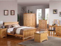 a bedroom scene complete with a bed, dresser and two nightstands in light wood