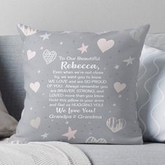 a gray pillow with pink hearts and stars on it