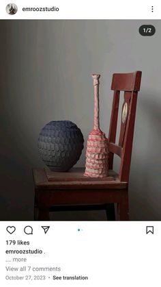 two vases sitting on top of a wooden chair