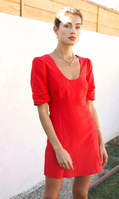 Bright, red dress with gathered, puff sleeves and a scoop neckline. Overall a simple design with elevating details, perfect for dates or professional events. The material is soft to touch and lightweight, Mini dress Scoop neck Gathered short sleeves Length: 34" Chest: 18" Waist: 14 3/4" Self: 70% Tencel, 30% Linen Lining: 60% Cotton, 40% Polyester Hand wash cold water with similar colors. Hang dry. Low iron, or dry clean Model is wearing a size small Style #: G235D5402 Bright Red Dress, Red Summer Dress, Red Summer Dresses, Professional Event, Scoop Neck Dress, Flowy Maxi Dress, Luxury Women Fashion, Low Iron, Strappy Heels