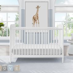 a baby's room with a giraffe painting on the wall next to a crib