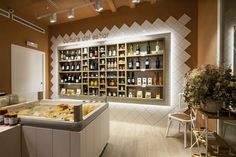 a store filled with lots of different types of bottles and containers on the wall next to a counter