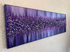 a purple painting hanging on the wall