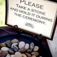 there is a sign that says please take a stone and hold it during the ceremony