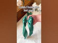 a person holding a green bow in their hand with the caption i wish i knew this last year