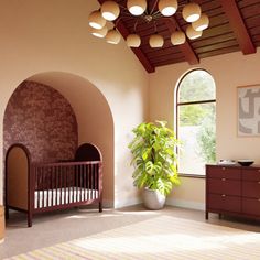 a room with a crib, dressers and a potted plant in it