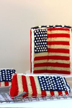 an american flag cake on a plate with two slices cut out and ready to be eaten