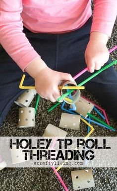 a toddler is playing with colored sticks and cubes while sitting on the floor