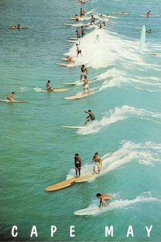 many people are surfing in the ocean on surfboards