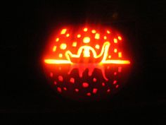 a pumpkin carved to look like it is lit up