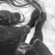 a woman with her hair blowing in the wind