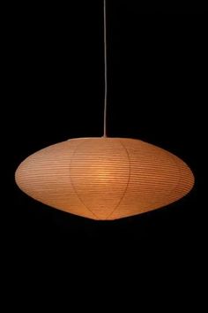 a wooden light hanging from a ceiling in the dark with no lighting bulbs on it