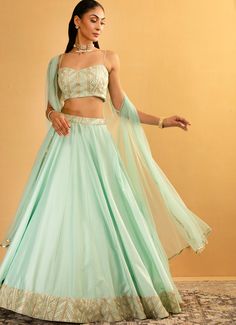 Embrace timeless beauty and impeccable craftsmanship with the Ice Blue Embroidered Skirt Cape Set, crafted from luxurious chanderi fabric. This exquisite ensemble features a flowing ice blue skirt that adds a touch of elegance to your look, perfectly paired with a gota work georgette blouse. Completed with a delicate net cape, draping gracefully over the shoulders to create a sophisticated and ethereal appearance. Ideal for Mehndi, Sangeet or as wedding guest attire, this ensemble is designed to make you feel like royalty. Composition : Skirt - Chanderi, Blouse - Georgette and Cape - Soft Net Care: Dry Clean Only and Vacuum Storage This product can be customized for sleeves, length and colour Delivery : 4-6 weeks as the product is hand crafted. Check Size Guide or choose MySize for free cu Elegant Designer Skirt With Resham Embroidery, Elegant Skirt With Resham Embroidery For Designer Wear, Elegant Georgette Skirt With Traditional Drape, Wedding Georgette Skirt With Traditional Drape, Elegant Long Skirt With Resham Embroidery, Traditional Georgette Skirt For Wedding, Traditional Georgette Wedding Skirt, Georgette Skirt With Traditional Drape For Reception, Reception Skirt In Georgette With Traditional Drape