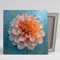 an orange flower on a blue background is displayed in a wooden frame with a white border around it