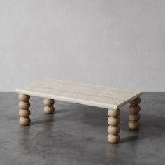 a table made out of wooden balls on a concrete floor