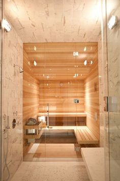 a large sauna in a bathroom with wooden walls