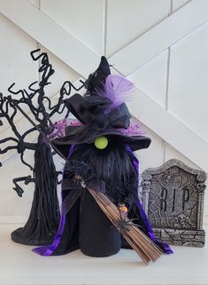 a witch hat and broom sitting on top of a table