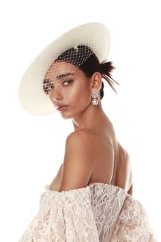 Add an extra touch of elegance to your bridal look with our Colette Bridal Boater Hat. A mixture of delicate lace, a floral embellishment, and netted veil creates a swoon worthy accessory. Simple lace crown Thick white band adorned with floral embellishment Wide white brim White netted veil Lace Crown, Lace Crowns, Bronx And Banco, Floral Embellishment, Gold Gown, Bridal Hat, Boater Hat, Bridal Look, White Band