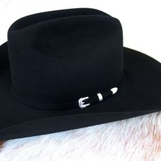 The Lariat combines legendary quality and classic Western style in one timeless package. It’s crafted from our proprietary 5X fur felt, which is prized for its durability and feel. As with all hats that come out of our factory in Texas, each Lariat is touched by more than 100 sets of hands during production, resulting in a hat that is designed and built to stand the test of time. This edition features a 7540 profile, which translates to a 4 5/8” cattleman crown and 4” brim. It’s finished with a Classic Top Hat For Western-themed Winter Events, Classic Flat Bill Top Hat For Western-themed Events, Classic Fur Felt Hats For Western-themed Events, Classic Fur Felt Top Hat For Country Events, Classic Top Hat With Flat Bill For Rodeo, Classic Adjustable Fur Felt Hat Bands, Classic Fitted Felt Riding Hat, Classic Fitted Felt Hat For Riding, Fitted Classic Felt Riding Hat