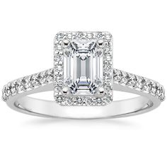 an emerald cut diamond ring with pave set shoulders