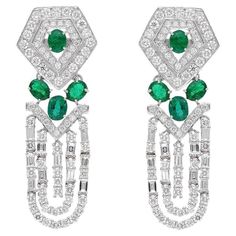 These exquisite earrings are handcrafted in 18-karat gold, 2.27 carats emerald and set in 3.99 carats of sparkling diamonds. FOLLOW MEGHNA JEWELS storefront to view the latest collection & exclusive pieces. Meghna Jewels is proudly rated as a Top Seller on 1stDibs with 5 star customer reviews. All items manufactured by us are handmade and can be customized or redesigned. Certificate available upon request. Composition Gross Weight : 13.04 Gms. Gold Net Weight : 11.79 Gms. Emerald Weight: 2.27 ct Emerald Art Deco, Emerald Art, Emerald Diamond Earrings, Oval Earrings, Diamond Earring, Gold Art Deco, Estilo Art Deco, Art Deco Earrings, White Gold Earrings