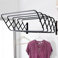 a rack with clothes hanging on it next to a shirt and t - shirt hanger