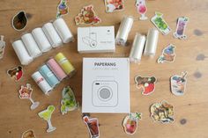 the contents of a papering kit laid out on a wooden table with stickers