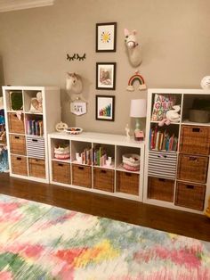 a living room filled with lots of furniture and pictures on the wall above it's bookshelf