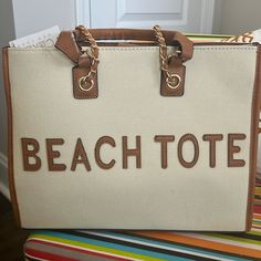 This Tote Bag Is Perfect For Your Summer Wardrobe. The Two Tone Colors Make The Bag Look Super Classy And Stylish. Top Handle Travel Bag For Beach Season, Summer Bags With Gold-tone Hardware And Top Handle, Summer Top Handle Bag With Gold-tone Hardware, Top Handle Beach Vacation Bags, Beige Bags With Gold-tone Hardware For Vacation, Top Handle Bags For Beach Season Vacation, Top Handle Bags For Beach Vacation, Vacation Bucket Bag With Gold-tone Hardware, Summer Tote Shoulder Bag With Gold-tone Hardware