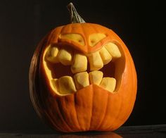 a pumpkin with teeth carved into it