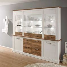 a white and brown cabinet with glass doors