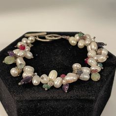 Nwot- Handmade Bracelet With Freshwater Pearls, Rubies, Aquamarine, Apatite, Amethyst, Kyanite And Tourmaline, With A Sterling Silver Toggle Clasp. 7.5 Inches Long. All Natural Stones, New Bracelet White Sterling Silver Hand-strung Jewelry, White Pearl Beaded Bracelets With Natural Stones, White Sterling Silver Bracelets, Handmade White Pearl Bracelet For Jewelry Making, Unique White Sterling Silver Bracelets, Handmade White Beaded Sterling Silver Bracelets, White Pearl Bracelets With Gemstones, White Pearl Gemstone Bracelets, Elegant White Beaded Bracelets With Gemstones