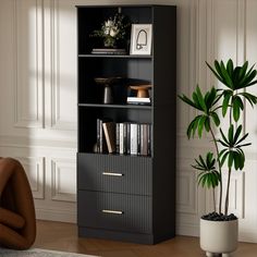 a black bookcase next to a potted plant