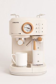 an espresso machine sitting on top of a white counter