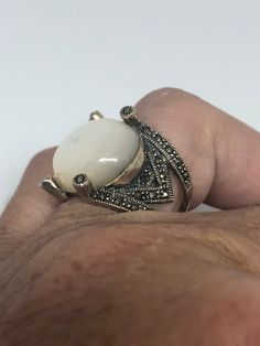 Mother of Pearl set in 925 Sterling Silver Marcasite ring I have size 5.75 Can be re sized for you, my jeweler would charge $10-$20 All rings are shipped in a nice gift box. Check out our over a THOUSAND great reviews Engraving is $4 per letter and is not always perfect depending on the piece. It can take a few days if the jeweler is busy. This is payable to Paypal Judithsltd@gmail.com Elegant Sterling Silver Dome Ring Collectible, Elegant Nickel-free Opal Ring For Gift, White Cabochon Crystal Ring Gift, Antique Silver Dome Ring As Gift, White Crystal Ring With Stone Setting As Gift, White Stone Setting Rings As Gift, White Rings With Stone Setting As Gift, Antique Marcasite Round Jewelry, White Oval Dome Ring Gift