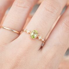 * ≈6x4mm oval peridot * Band width: ≈1.3mm * G color SI diamonds, ≈0.04ctw * Setting style: Prong setting, low profile (sits flush on your finger) * Material: Solid 14k yellow gold, rose gold or white gold * Made of 100% recycled precious metal and ethically sourced gemstone * Comes in a gift box with a bow ready for gifting * Handmade with love and great care in New York * Please note that colors may vary slightly as they are genuine gemstones. Our Dedication All our jewelry is designed and cre Oval Green Rose Cut Diamond Rings, Oval Peridot Birthstone Ring For May, Oval Lime Green Ring For Gift, Oval Peridot Birthstone Ring With Accent Stones, Oval Peridot Birthstone Ring For Anniversary, Oval Peridot Solitaire Jewelry, Oval Peridot Ring In Yellow Gold, Oval Yellow Gold Peridot Rings, Green Peridot Birthstone Ring, Dainty Style