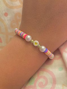 a woman's arm with a bracelet made out of beads and glass beads on it