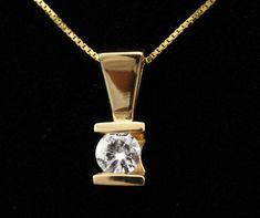 "Features * ITEM #: 3300P * METAL TYPE: 14 Karat Yellow Gold * AVAILABLE IN: Rose Gold, Yellow Gold, White Gold * STONES USED: Diamond * DIAMOND QTY:1 * DIAMOND SHAPE:ROUND * DIAMOND WEIGHT-.25Ct COLOR AND CLARITY g-i1 * SETTING TYPE: Hand Channel Set WEIGHT 2,1 gm LONG 13mm with bail Width 4.5mm * READY TO SHIP: in 3-5 Business Days FOR ADDITIONAL QUESTIONS ABOUT THIS PRODUCT: Please feel free to message us. We are quick to respond to all your inquiries. PLEASE choose as \"FAVORITE\" on the rig Vvs Clarity Solitaire Pendant Necklace For Formal Occasions, Anniversary Yellow Gold Solitaire Necklace Vvs Clarity, Anniversary Vvs Clarity Yellow Gold Solitaire Necklace, Formal Yellow Gold Diamond Necklace With Tension Setting, Diamond White Solitaire Necklace With Tension Setting For Anniversary, Luxury Solitaire Necklace With Single Diamond For Formal Occasions, Anniversary Diamond Necklace With Tension Setting In Round Cut, Anniversary Diamond Necklace With Round Cut Tension Setting, Fine Jewelry Diamond Necklace With Tension Setting