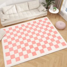 a living room with a checkered rug on the floor and a couch in front of it