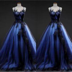 two dresses on mannequins, one in blue and the other in black