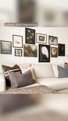 a living room filled with lots of pictures on the wall above a white sectional couch