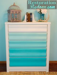 there is a blue and white dresser in the room