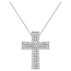 Make a bold statement of style and beliefs with the eye-catching elegance of this diamond cross pendant. Beautifully crafted by our inhouse experts in 14 karat white gold and embellished with 73 round brilliant cut & baguette cut diamond set in prong setting. The total diamond weight is 3.0 carat and it shines in H-I color I2 clarity. Pendant suspends along a cable chain that secures with a spring-ring clasp. White Gold Cross Pendant, Gold Cross Pendant, Diamond Cross Pendants, Baguette Cut Diamond, Diamond Cross, Gold Cross, Baguette Cut, Baguette Diamond, Spring Rings