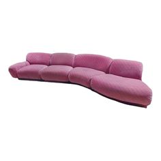 a pink couch sitting on top of a white floor