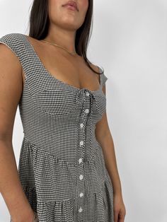 A cap sleeve button down dress with cup detailing and an adjustable tie back. Gingham printed material with no stretch. Runs Small! We suggest sizing up, especially for larger chests. 75% Cotton, 25% Rayon. Grace is wearing size Small. Refer to our Size Chart for Model Measurements. Questions about fit? Text us anytime! 614-358-6377 Grey Gingham, Gingham Mini Dress, Short Skirts Outfits, Clothing Jewelry, Tiered Mini Dress, College Fits, Bodysuit Fashion, Down Dress, Gingham Print