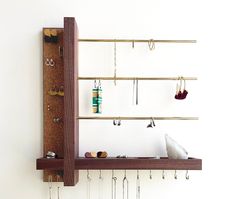 a wall mounted jewelry rack with earrings on it